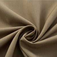 Close-up of Longan Craft’s Thick Cotton Gabardine Fabric By The Yard, a plain color twill ideal for uniforms, twisted to highlight its smooth texture and soft folds.