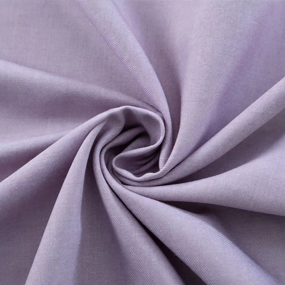 A close-up of Longan Craft’s Thick Cotton Gabardine Fabric By The Yard in light purple, twisted to show its smooth twill texture, soft folds, and plain color—an ideal gabardine material for uniforms.
