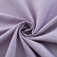 A close-up of Longan Craft’s Thick Cotton Gabardine Fabric By The Yard in light purple, twisted to show its smooth twill texture, soft folds, and plain color—an ideal gabardine material for uniforms.