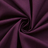 Close-up of Thick Cotton Gabardine Fabric by Longan Craft, twisted into a swirl to highlight its smooth texture, soft deep purple twill weave, and gentle folds—ideal for uniforms and available by the yard.