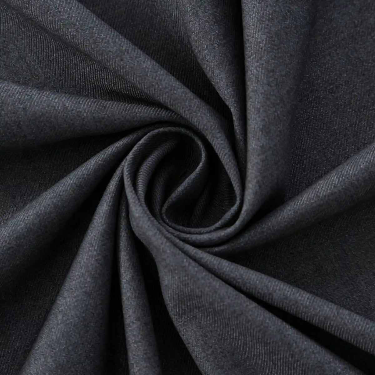 Close-up of Longan Craft Thick Cotton Gabardine Fabric, twisted in a spiral to show its soft texture and subtle twill weave. Plain color heavyweight gabardine—ideal material for uniforms, sold by the yard.