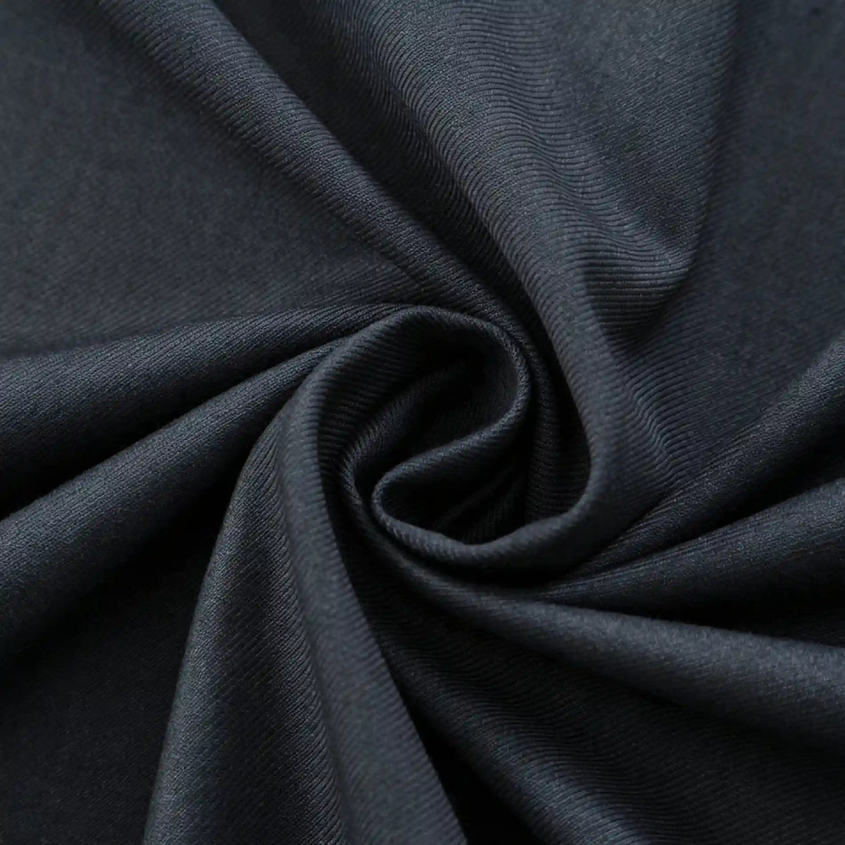Close-up of Longan Craft’s Thick Cotton Gabardine Fabric By The Yard, a plain color twill gabardine ideal for uniforms, highlighting its smooth texture and refined weave in a twisted swirl arrangement.