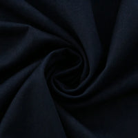 Close-up of Longan Craft Thick Cotton Gabardine Fabric by the Yard in navy blue, twisted to show its smooth, subtly textured, heavyweight cotton-polyester twill—an ideal material for uniforms with a soft feel and gentle sheen.