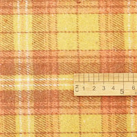 A wooden ruler marked in centimeters from 1 to 7 measures a piece of Longan Craft Thick Plaid Mammoth Flannel Fabric By The Yard, showcasing the heavyweight cotton brushed texture and the warm yellow, orange, and brown checkered pattern typical of this premium warm apparel fabric.