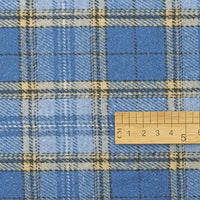 A wooden ruler rests atop Longan Craft’s Thick Plaid Mammoth Flannel Fabric By The Yard, a heavyweight cotton brushed flannel featuring light and dark blue, white, and beige checkered stripes—ideal for accurate measurements or selecting this warm apparel fabric by the yard.