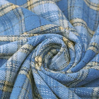 A close-up of blue and beige plaid flannel fabric from Longan Craft, arranged in a spiral to showcase the soft texture and intersecting lines of their Thick Plaid Mammoth Flannel Fabric by the Yard—a heavyweight brushed cotton material ideal for cozy apparel projects.