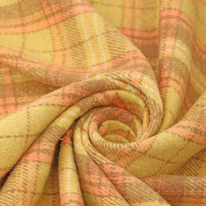 A close-up of Thick Plaid Mammoth Flannel Fabric by the Yard from Longan Craft, swirled in a spiral to display its yellow and orange intersecting lines and soft, heavyweight cotton brushed texture—ideal for anyone seeking warm flannel apparel fabric.
