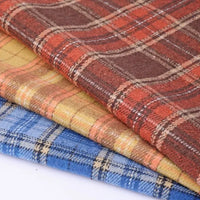 Three folded pieces of Longan Craft Thick Plaid Mammoth Flannel Fabric By The Yard in red, yellow, and blue are stacked together, highlighting their vibrant checkered patterns and the soft, heavyweight cotton brushed flannel texture. Ideal for cozy projects, this warm flannel apparel fabric adds both comfort and style to any creation.