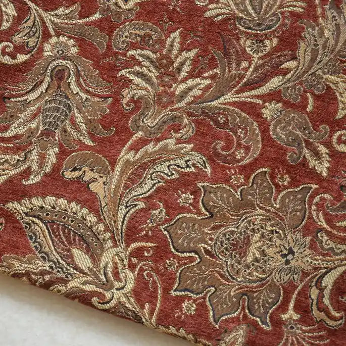 A close-up of Longan Craft's Thick Viscose Chenille Fabric By The Yard shows its rich botanical jacquard pattern in gold, brown, and beige on deep red—a durable chenille material perfect for draperies and upholstery.
