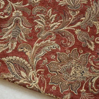 A close-up of Longan Craft's Thick Viscose Chenille Fabric By The Yard shows its rich botanical jacquard pattern in gold, brown, and beige on deep red—a durable chenille material perfect for draperies and upholstery.