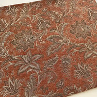 A close-up of Longan Craft's Thick Viscose Chenille Fabric By The Yard shows an ornate botanical paisley jacquard in brown, beige, and reddish-brown—ideal for elegant, durable chenille draperies or upholstery.