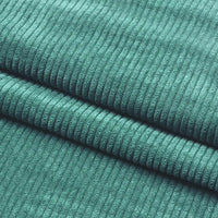Close-up of Longan Craft Thick 8 Wale Corduroy Fabric By the Yard shows its soft teal upholstery texture and evenly spaced vertical ridges, with two folds clearly visible.