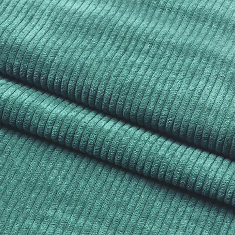 Close-up of Longan Craft Thick 8 Wale Corduroy Fabric By the Yard shows its soft teal upholstery texture and evenly spaced vertical ridges, with two folds clearly visible.