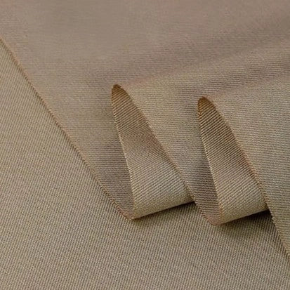 A close-up of Longan Craft’s Twill Cotton Lyocell Fabric by the yard, a smooth, solid color material with a subtle diagonal weave, shown partially folded to highlight its comfy and breathable texture for shirts.