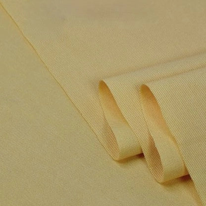 A close-up of Longan Craft’s Twill Cotton Lyocell Fabric By The Yard reveals its smooth, cream-colored surface and subtle diagonal weave—perfect, comfy, and breathable for shirts.