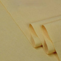 A close-up of Longan Craft’s Twill Cotton Lyocell Fabric By The Yard reveals its smooth, cream-colored surface and subtle diagonal weave—perfect, comfy, and breathable for shirts.