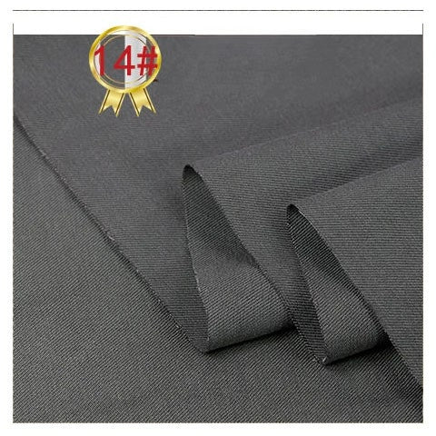 Close-up of Longan Craft's Twill Cotton Lyocell Fabric By The Yard, featuring a smooth, dark gray texture folded neatly. A gold ribbon icon with "14#" in red appears at the top left. Perfect comfy and breathable material for shirts.