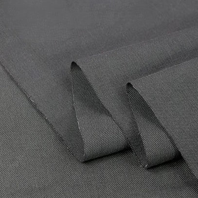 A close-up of Twill Cotton Lyocell Fabric by Longan Craft shows the solid dark grey, comfy, and breathable material—ideal for shirts. This eco-friendly Cotton Lyocell textile is smooth, slightly textured, and durable for versatile use.