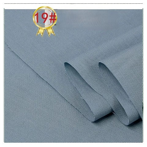 Light blue-gray Twill Cotton Lyocell Fabric by the yard from Longan Craft, laid out flat with two folded edges; a gold medal with 19# in red appears in the top left corner. Comfy and breathable—ideal for shirts.