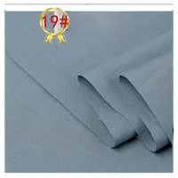 Light blue-gray Twill Cotton Lyocell Fabric by the yard from Longan Craft, laid out flat with two folded edges; a gold medal with 19# in red appears in the top left corner. Comfy and breathable—ideal for shirts.