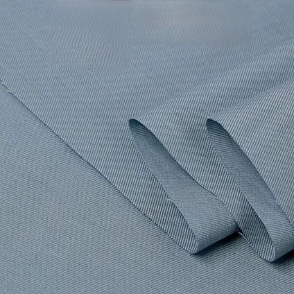 Light blue Twill Cotton Lyocell Fabric by the yard from Longan Craft, featuring an eco-friendly, comfy, and breathable solid material with a subtle diagonal twill weave—perfect for shirts. Texture and weave are clearly visible on the neatly folded fabric.