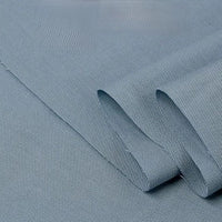 Light blue Twill Cotton Lyocell Fabric by the yard from Longan Craft, featuring an eco-friendly, comfy, and breathable solid material with a subtle diagonal twill weave—perfect for shirts. Texture and weave are clearly visible on the neatly folded fabric.