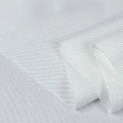A close-up of Longan Craft’s Twill Cotton Lyocell Fabric by the yard—solid white, soft, smooth, and breathable—folded neatly against a plain background, perfect for comfy shirts.