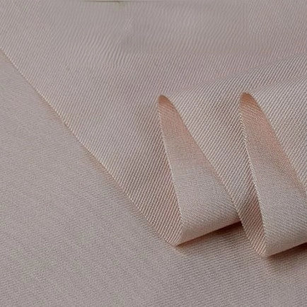 A close-up of Longan Craft’s Twill Cotton Lyocell Fabric by the yard reveals fine diagonal lines and a soft, smooth texture, highlighting its comfy, breathable quality—ideal for shirts and solid-color eco-friendly projects.