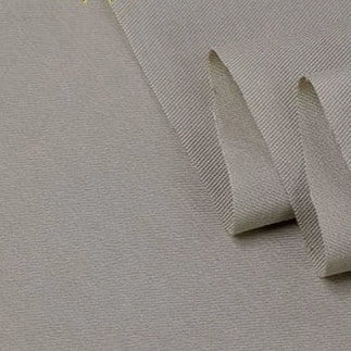 A close-up of Longan Craft’s Twill Cotton Lyocell Fabric By The Yard in light grey shows its textured, eco-friendly weave and thickness—ideal as a comfy, breathable material for shirts.