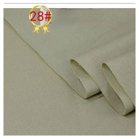 Close-up of Longan Craft's Twill Cotton Lyocell Fabric By The Yard in light olive green, showcasing its subtle diagonal weave and partial fold. A 28# gold badge appears in the top left corner. Ideal for comfy, breathable shirts.