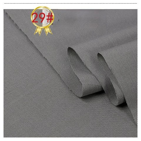 A close-up of smooth, folded Twill Cotton Lyocell Fabric by Longan Craft in gray, with a gold and red 29# badge in the corner, showing its comfy, breathable quality ideal for shirts.