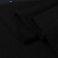 A close-up of Longan Craft Twill Cotton Lyocell Fabric by the yard in solid black, showing a visible fold that highlights its smooth texture and soft, comfy, breathable material—ideal for shirts.