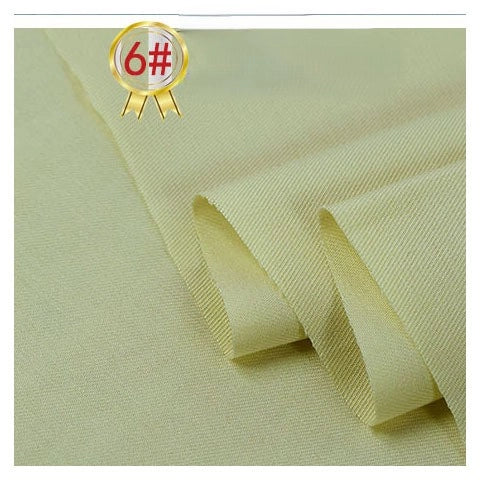 Light yellow Twill Cotton Lyocell Fabric By The Yard from Longan Craft is shown folded with a 6# gold badge. This comfy, breathable textile features a smooth, slightly textured surface and highlights the soft, fine look of this eco-friendly material.