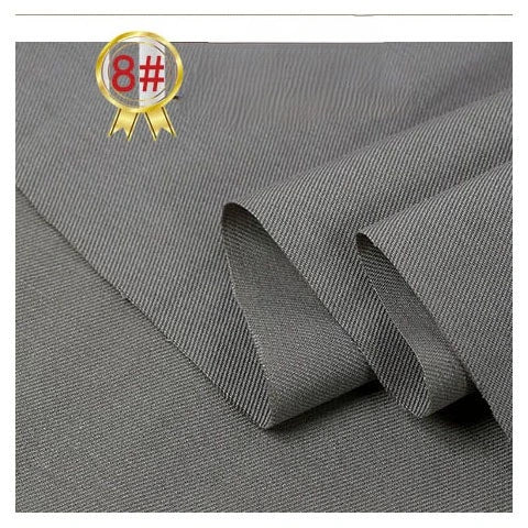 Longan Craft's Twill Cotton Lyocell Fabric By The Yard features a fine diagonal weave and comes in a solid color. Shown partially folded with an 8# gold badge, this comfy, breathable textile is ideal for shirts and offers eco-friendly style.