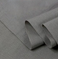 A close-up of Longan Craft's Twill Cotton Lyocell Fabric By The Yard in light gray, showcasing its subtle diagonal weave and folded edge—an eco-friendly, comfy, and breathable textile ideal for shirts.