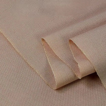 A close-up of Longan Craft's Twill Cotton Lyocell Fabric By The Yard, a light beige solid color textile with a smooth, slightly shiny surface and neat folds—perfectly comfy and breathable for shirts.