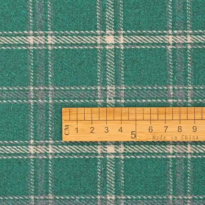 A Longan Craft wooden ruler marked “Made in China” is placed on Vintage Checked Mammoth Flannel Fabric by the yard—a soft, thick cotton gingham flannelette sewing material with a green and white checked pattern. The ruler shows centimeter measurements from 0 to 10.
