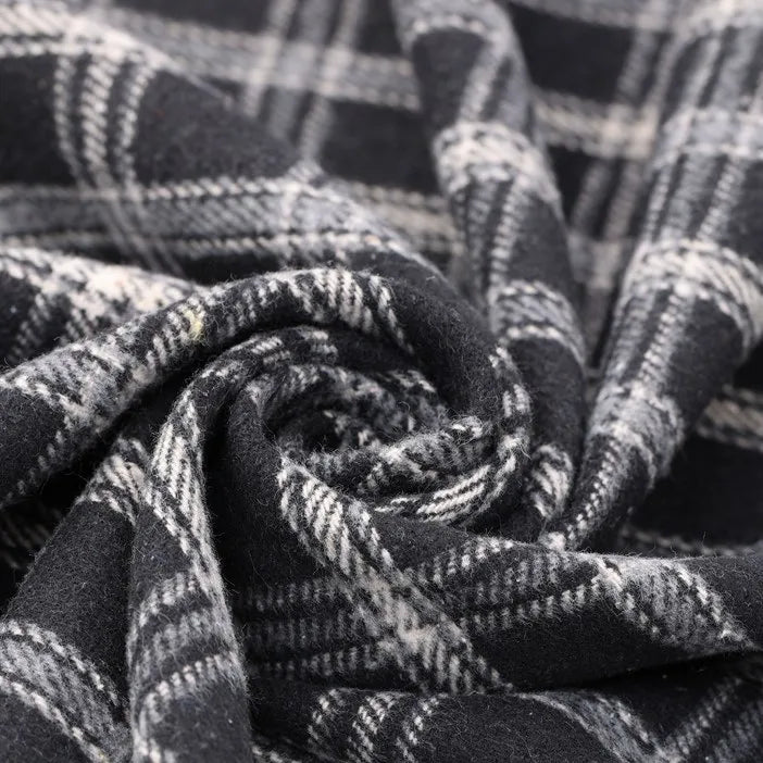 A close-up of Longan Craft’s Vintage Checked Mammoth Flannel Fabric by the yard reveals its thick cotton gingham texture and detailed black and white check pattern, twisted into a spiral to showcase the material’s soft, cozy flannelette perfect for fall sewing projects.