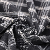 A close-up of Longan Craft’s Vintage Checked Mammoth Flannel Fabric by the yard reveals its thick cotton gingham texture and detailed black and white check pattern, twisted into a spiral to showcase the material’s soft, cozy flannelette perfect for fall sewing projects.