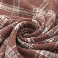 Close-up of the Vintage Checked Mammoth Flannel Fabric by Longan Craft, featuring a soft, brown and beige gingham pattern swirled into a spiral. This thick cotton flannelette fabric is warm and textured, perfect for cozy clothing or blankets.