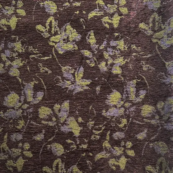 A close-up of Longan Craft’s Vintage Flower Pattern Chenille Fabric by the yard shows a brown background with abstract yellow and pale purple floral jacquard, featuring scattered, softly blurred flowers and leaves—ideal for home décor.