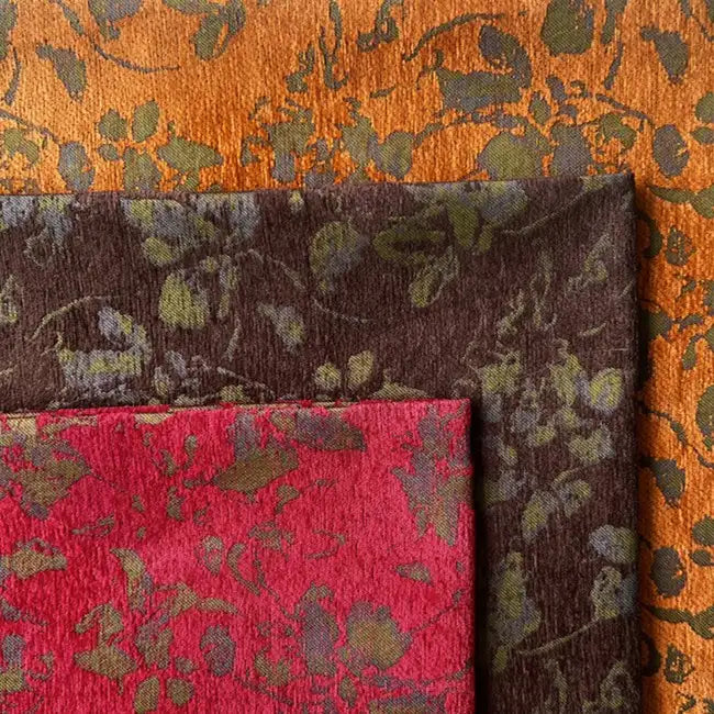 Three overlapping Vintage Flower Pattern Chenille fabrics by Longan Craft: orange with greenish leafy motif, dark brown with green, and red with green. All are Jacquard chenille, perfect for decorative pillows and home decor.