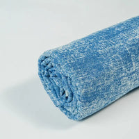Longan Craft's Washed Denim Fabric By The Yard is shown rolled up on a white background. This premium vintage cotton denim textile features a blue and white mottled pattern, offering a soft, plush feel for casual, cozy jeans and crafts.