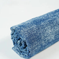 Longan Craft Washed Denim Fabric By The Yard is a premium, vintage cotton denim cloth with a mottled texture and soft feel, shown rolled up on a white surface. Ideal for jeans and other sewing projects.