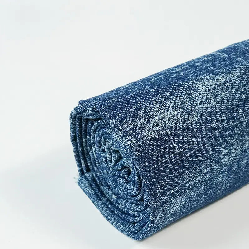 Longan Craft’s Washed Denim Fabric by the Yard features premium, vintage-style cotton denim with a soft, mottled blue texture—ideal for jeans and crafts—shown rolled on a plain white background.