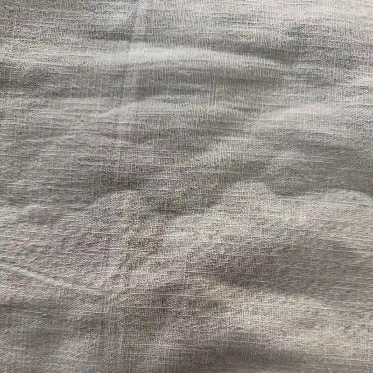 Close-up of Longan Craft's Washed Ramie Fabric by the Yard shows light gray, medium weight ramie cotton with visible weave and soft folds, emphasizing its breathable, sustainable texture—ideal as a linen alternative for apparel.