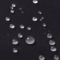 Small water droplets on Longan Craft's Waterproof Gabardine Fabric By The Yard show the water-resistant quality of this solid color twill gabardine textile, perfect for durable workwear and versatile outdoor use.