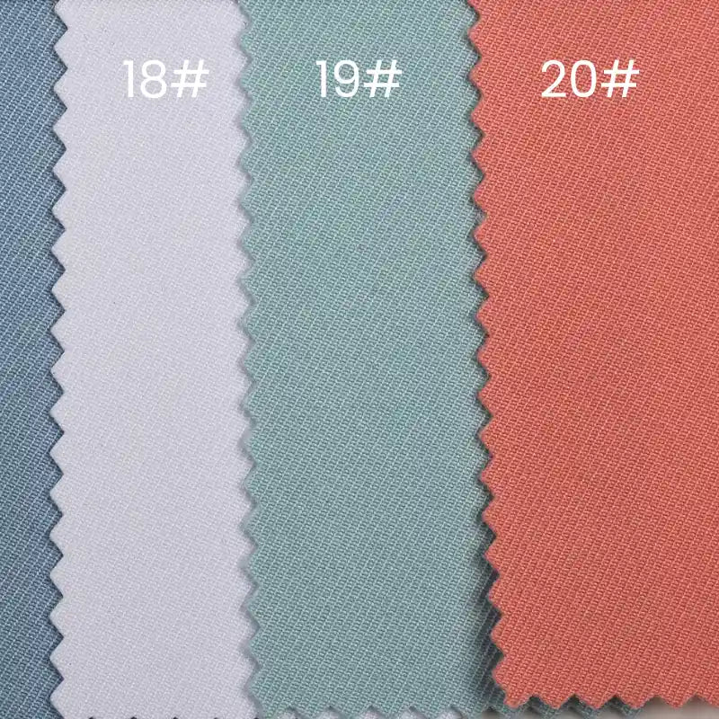 Three swatches of Longan Craft's Waterproof Gabardine Fabric by the yard—in blue (18#), light green (19#), and coral (20#)—display zigzag-cut, water-resistant twill ideal for workwear, arranged neatly side by side.
