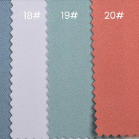 Three swatches of Longan Craft's Waterproof Gabardine Fabric by the yard—in blue (18#), light green (19#), and coral (20#)—display zigzag-cut, water-resistant twill ideal for workwear, arranged neatly side by side.