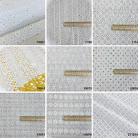 A collage of nine White Floral Eyelet Embroidered Voile fabric samples by Longan Craft, 100% cotton, some with rulers for scale. Mostly white embroidered; one shows yellow accents. Each sample displays a reference number in the corner.